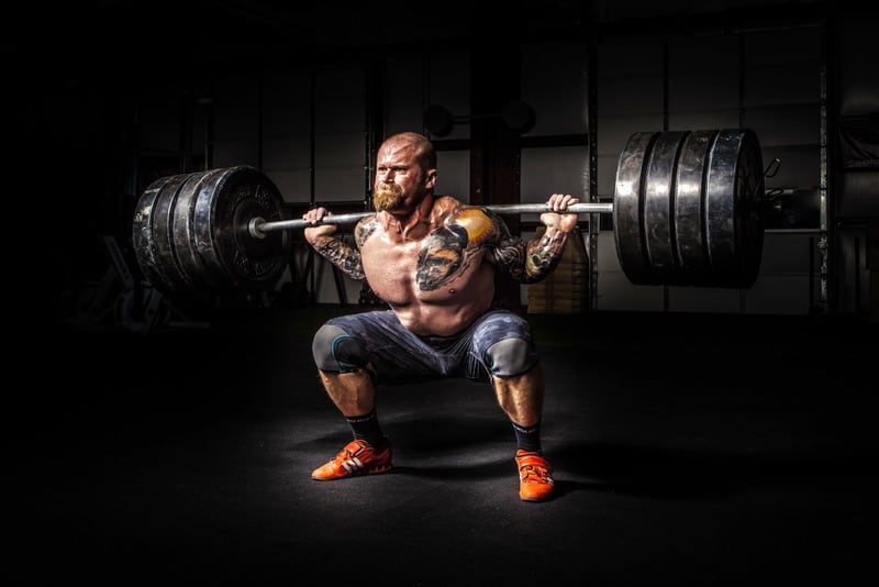 man squatting 405 pounds