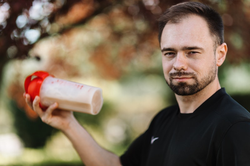 man holding a mass gainer shake