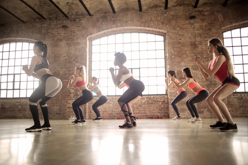 females squatting in a gym