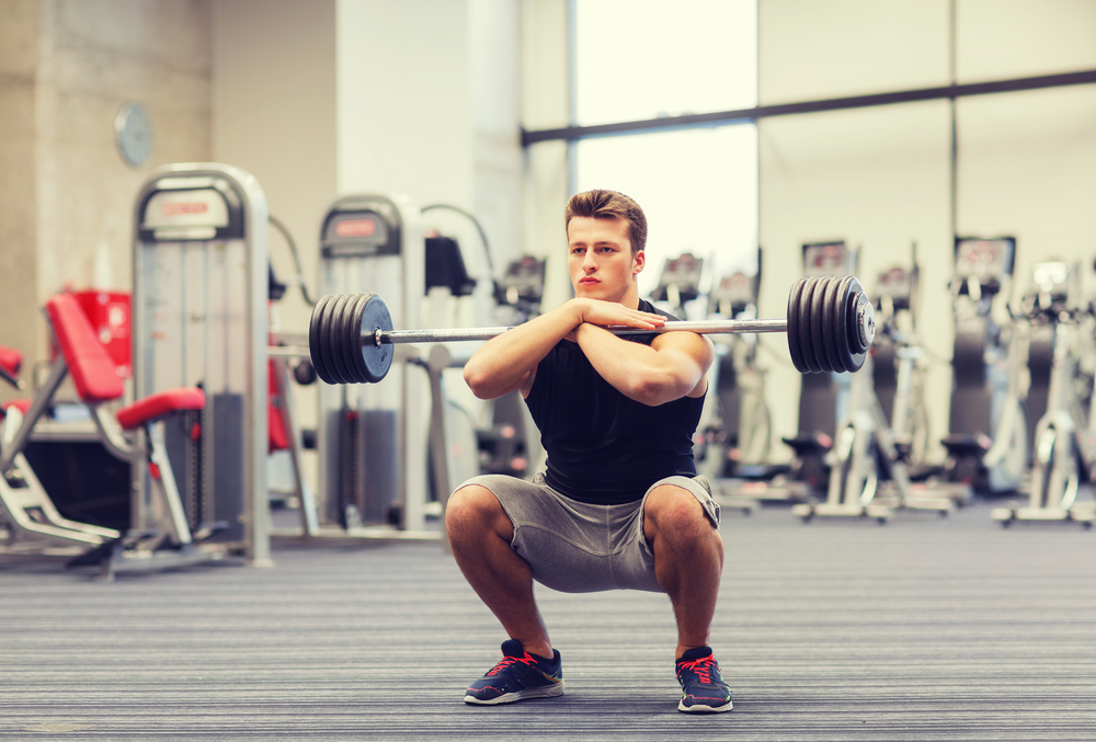 Man doing a front squat in a gym