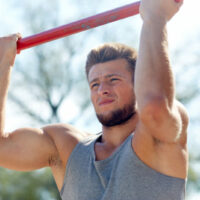 Man doing a chin-up outdoors
