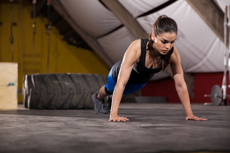 Female doing a push up in a crossfit gym