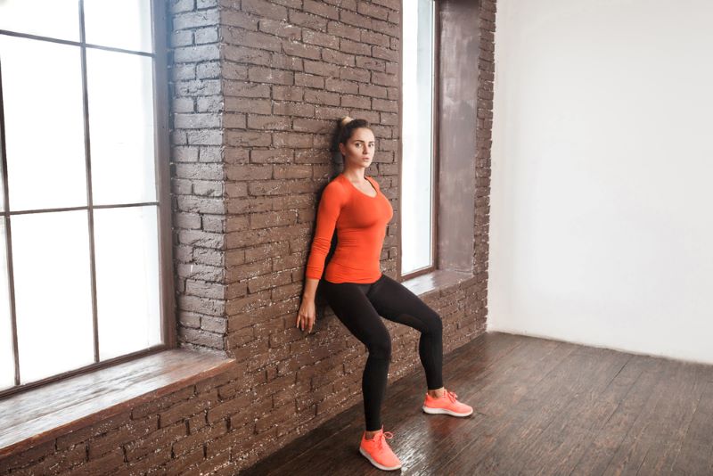 woman doing a wall sit