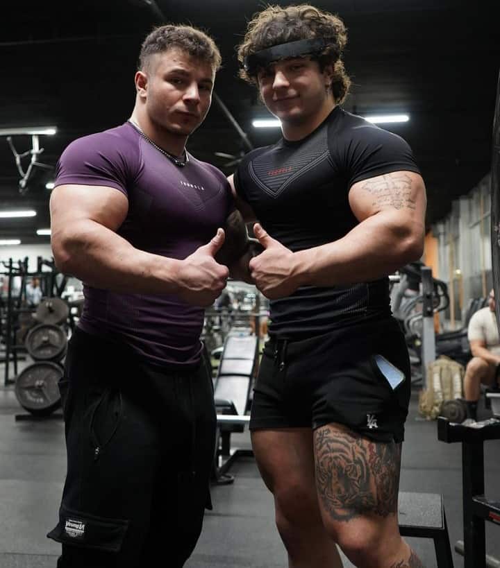 The Tren Twins posing in a gym